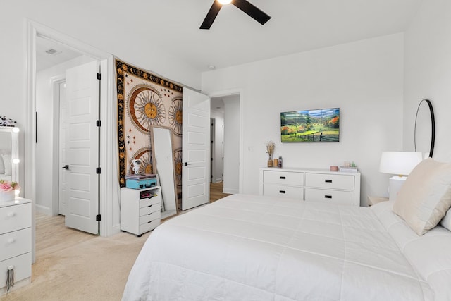 bedroom with ceiling fan and light colored carpet