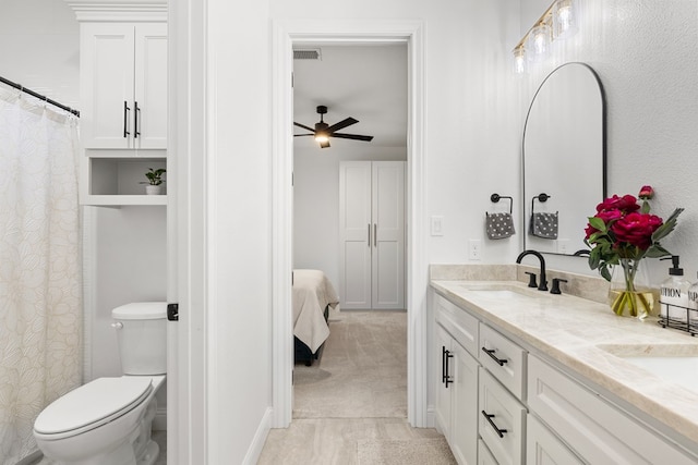 bathroom with ceiling fan, vanity, and toilet