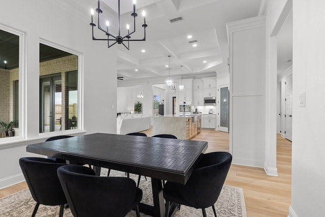 dining room featuring coffered ceiling, beamed ceiling, a notable chandelier, crown molding, and light hardwood / wood-style floors