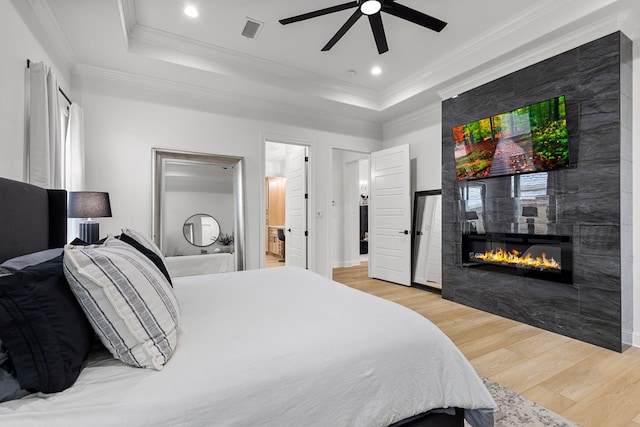 bedroom featuring connected bathroom, ceiling fan, hardwood / wood-style floors, and crown molding