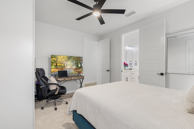 bedroom with light colored carpet, ensuite bath, and ceiling fan