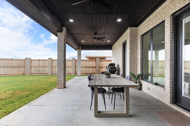 view of patio with area for grilling and ceiling fan