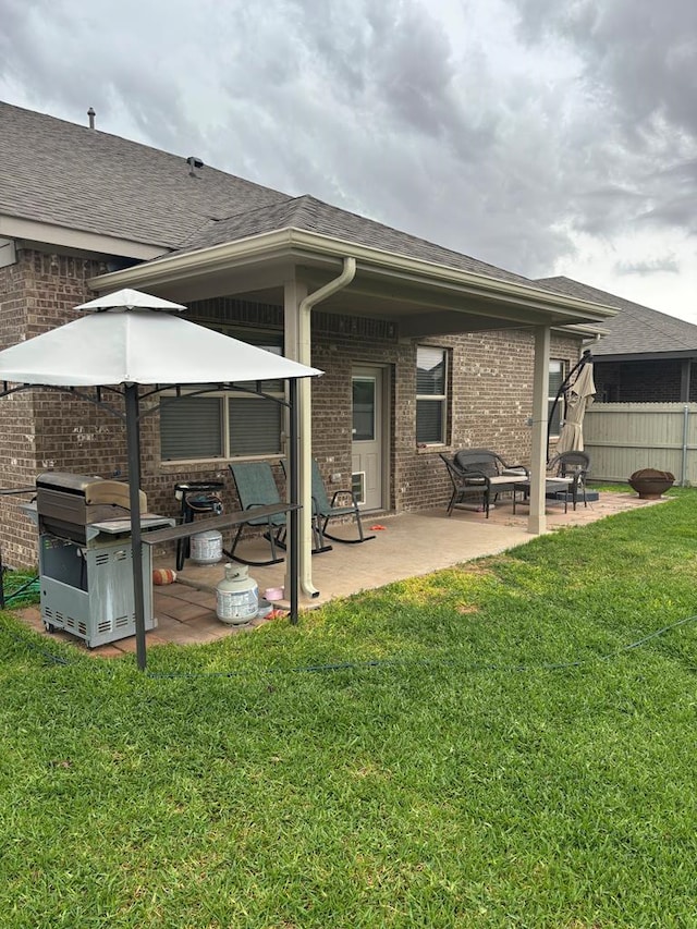 6912 Boss Rnch, Odessa, TX 79765 - back of property featuring brick siding, a patio, and roof with shingles