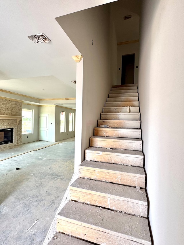 44 La Fauna Dr, Odessa, TX 79765 - stairs featuring a brick fireplace and concrete floors