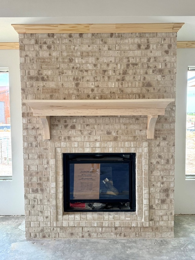 44 La Fauna Dr, Odessa, TX 79765 - detailed view of concrete floors, a brick fireplace, and ornamental molding