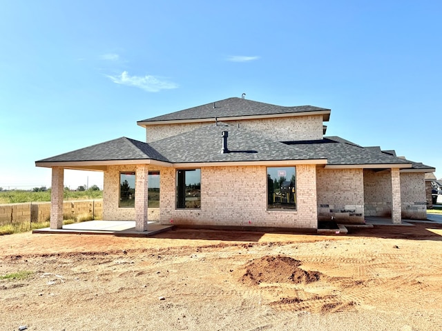 44 La Fauna Dr, Odessa, TX 79765 - back of house with a patio, a shingled roof, and brick siding