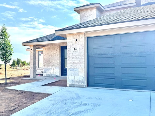 44 La Fauna Dr, Odessa, TX 79765 - entrance to property featuring brick siding, stone siding, and driveway