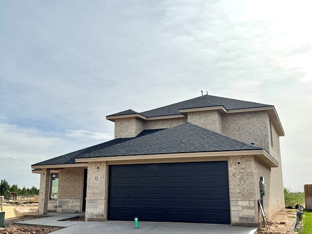 44 La Fauna Dr, Odessa, TX 79765 - view of property exterior featuring brick siding, roof with shingles, a garage, and concrete driveway