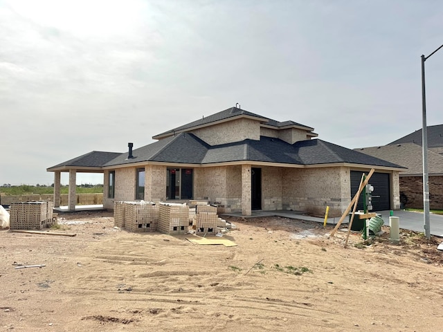 44 La Fauna Dr, Odessa, TX 79765 - back of house featuring a garage and driveway
