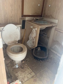 1302 S Texas Ave, Odessa, TX 79761 - bathroom with toilet and wood walls