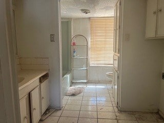 1302 S Texas Ave, Odessa, TX 79761 - full bathroom featuring vanity, tile patterned flooring, and a bathtub