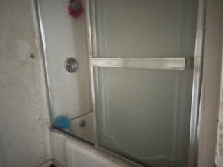1302 S Texas Ave, Odessa, TX 79761 - bathroom view of combined bath / shower with glass door