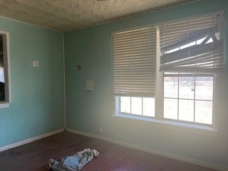 1302 S Texas Ave, Odessa, TX 79761 - empty room featuring baseboards and wood finished floors