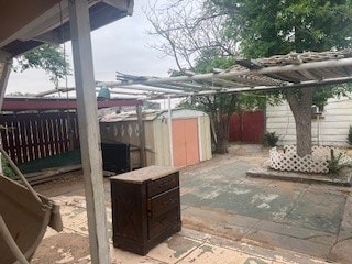 1302 S Texas Ave, Odessa, TX 79761 - fenced backyard with a shed and a patio