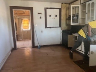 1302 S Texas Ave, Odessa, TX 79761 - kitchen featuring wood finished floors and dark countertops