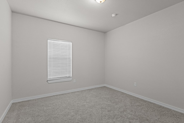 2227 W 3rd St, Odessa, TX 79763 - spare room with carpet flooring, baseboards, and a smoke detector