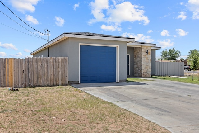 2227 W 3rd St, Odessa, TX 79763 - view of front of property featuring a garage, concrete driveway, and stucco siding