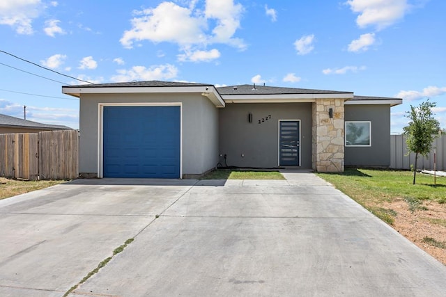 2227 W 3rd St, Odessa, TX 79763 - view of front of property featuring a garage, stucco siding, and driveway