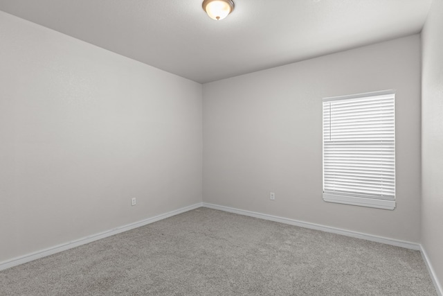 2227 W 3rd St, Odessa, TX 79763 - spare room featuring carpet flooring and baseboards
