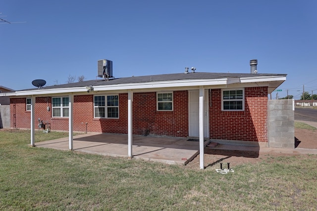 1500 S Bruce Ave, Monahans, TX 79756 - rear view of property with a yard, a patio area, and brick siding