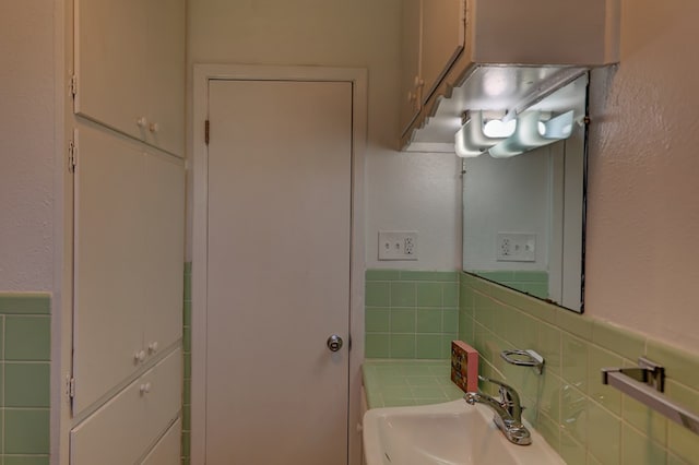 1500 S Bruce Ave, Monahans, TX 79756 - bathroom featuring tile walls, a textured wall, and a wainscoted wall