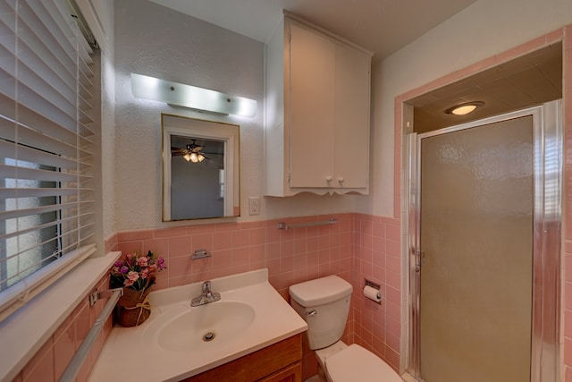 1500 S Bruce Ave, Monahans, TX 79756 - full bathroom with vanity, a shower stall, tile walls, and a wainscoted wall
