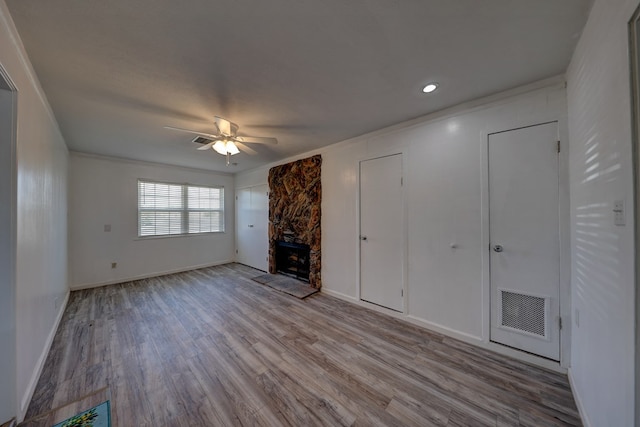 1500 S Bruce Ave, Monahans, TX 79756 - unfurnished living room with a ceiling fan, wood finished floors, a fireplace, and crown molding