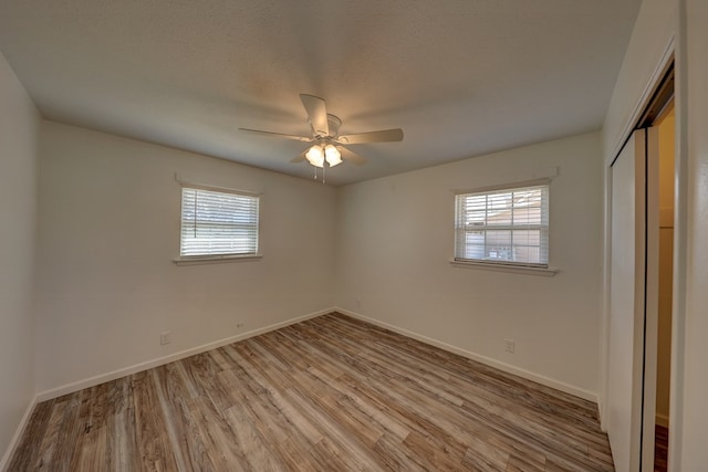 1500 S Bruce Ave, Monahans, TX 79756 - unfurnished bedroom featuring wood finished floors, a closet, and ceiling fan