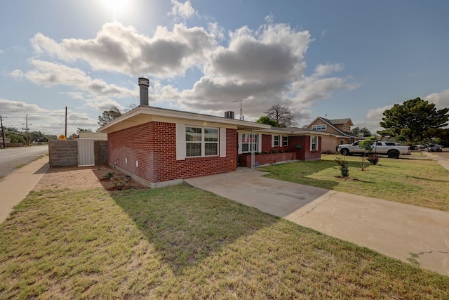 1500 S Bruce Ave, Monahans, TX 79756 - ranch-style home with brick siding, a front lawn, and concrete driveway