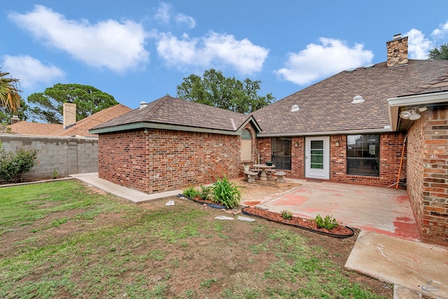 6415 San Mateo Ln, Odessa, TX 79762 - back of house featuring brick siding, a patio, and a chimney