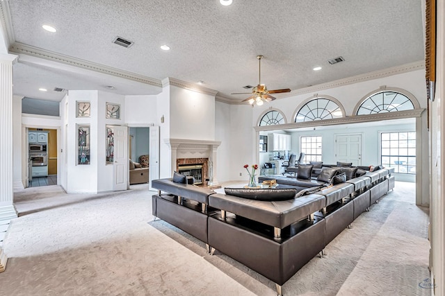 6415 San Mateo Ln, Odessa, TX 79762 - living room featuring crown molding, light carpet, a textured ceiling, a fireplace, and ceiling fan