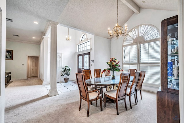 6415 San Mateo Ln, Odessa, TX 79762 - dining space featuring ornate columns, light colored carpet, a chandelier, a textured ceiling, and high vaulted ceiling