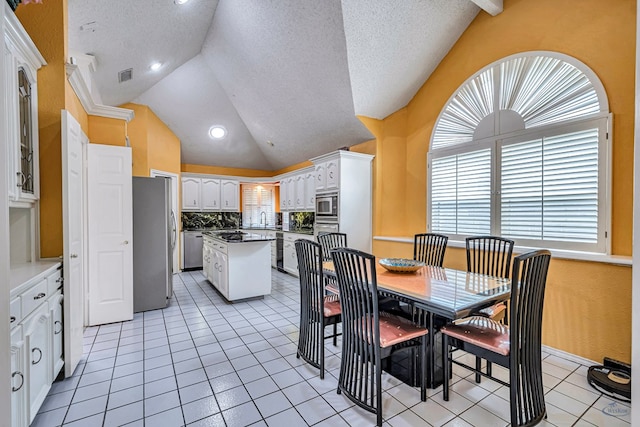 6415 San Mateo Ln, Odessa, TX 79762 - dining room featuring vaulted ceiling, light tile patterned floors, a textured ceiling, and recessed lighting