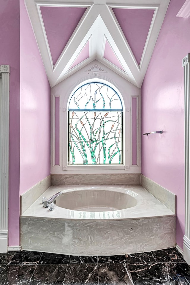 6415 San Mateo Ln, Odessa, TX 79762 - bathroom featuring marble look tiles, a bath, and lofted ceiling