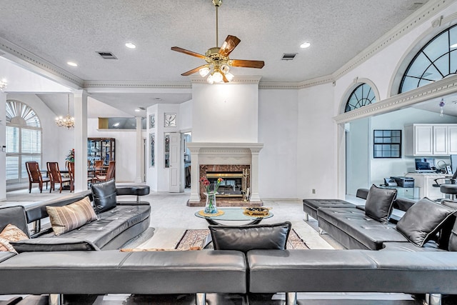 6415 San Mateo Ln, Odessa, TX 79762 - living room with a textured ceiling, a ceiling fan, a chandelier, crown molding, and a high end fireplace