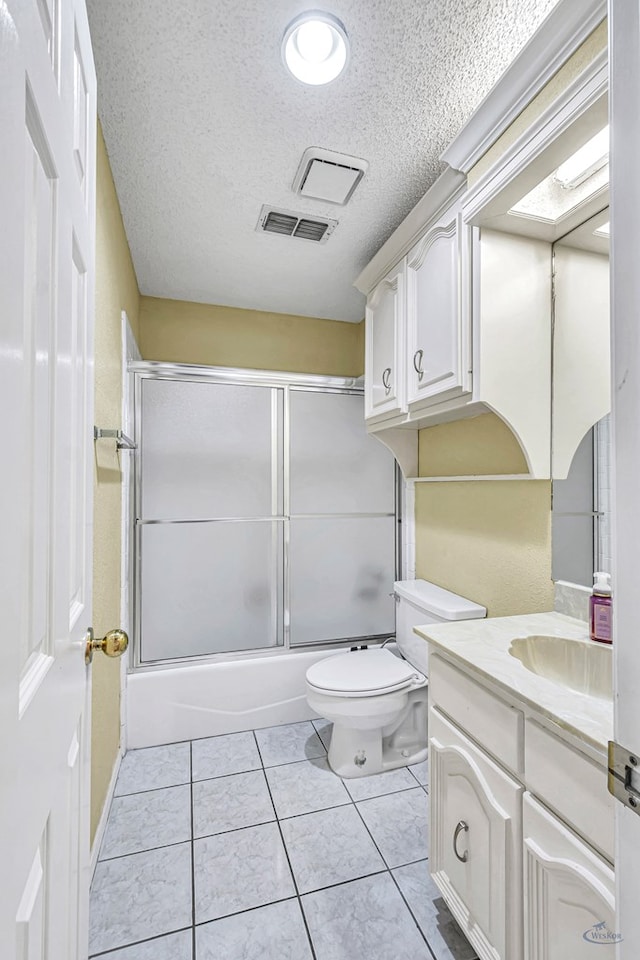 6415 San Mateo Ln, Odessa, TX 79762 - full bathroom featuring vanity, a textured ceiling, enclosed tub / shower combo, and tile patterned floors