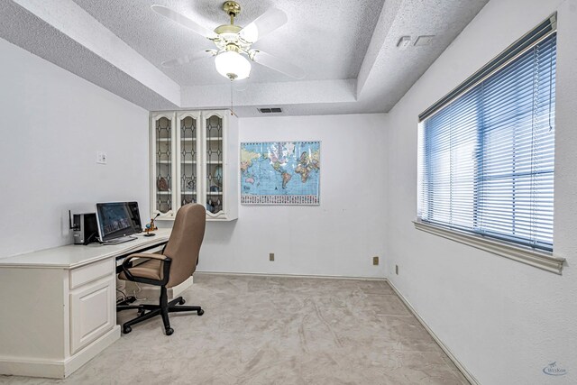 6415 San Mateo Ln, Odessa, TX 79762 - home office featuring a tray ceiling, a textured ceiling, a ceiling fan, and light colored carpet