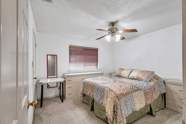 6415 San Mateo Ln, Odessa, TX 79762 - bedroom with light colored carpet, a textured ceiling, and ceiling fan