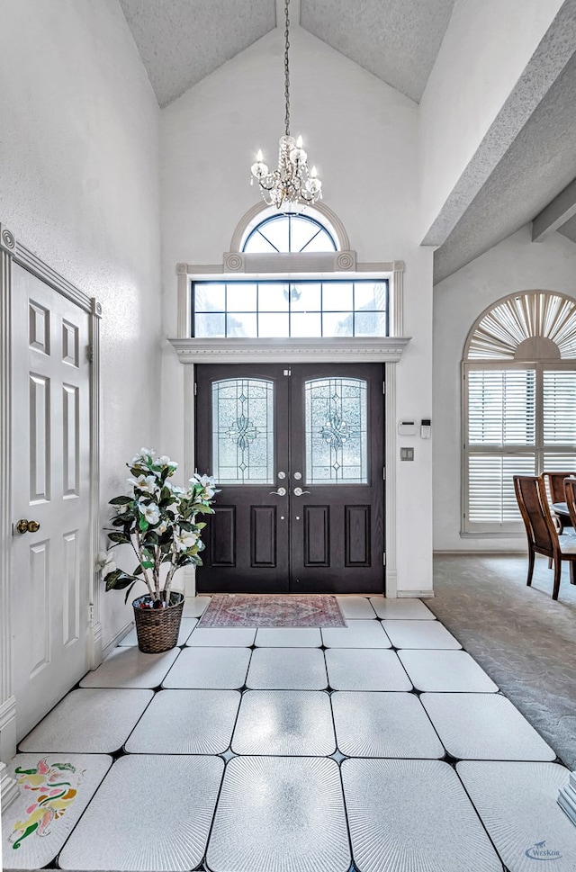 6415 San Mateo Ln, Odessa, TX 79762 - foyer featuring high vaulted ceiling, a chandelier, and healthy amount of natural light