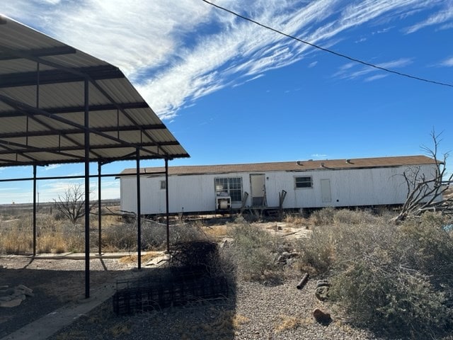 rear view of property with a carport