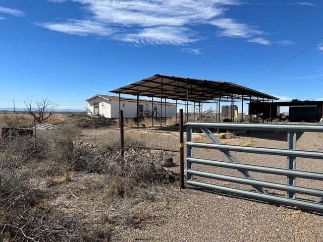 view of yard featuring an outdoor structure and a rural view