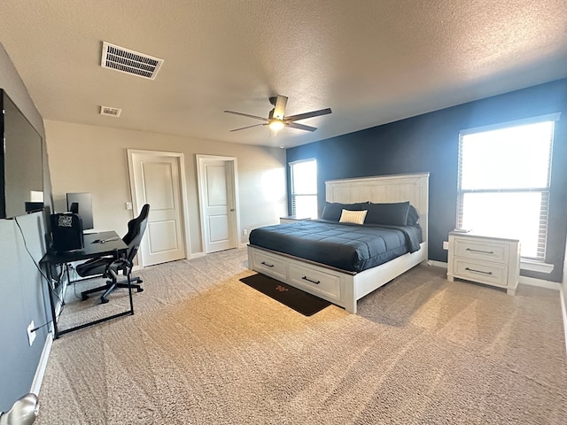 1311 Red Cliff Ave, Odessa, TX 79765 - bedroom featuring light colored carpet, a textured ceiling, a desk, and ceiling fan