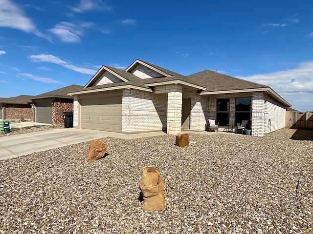 1311 Red Cliff Ave, Odessa, TX 79765 - ranch-style home featuring an attached garage, brick siding, driveway, and roof with shingles