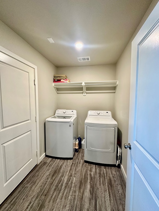 1311 Red Cliff Ave, Odessa, TX 79765 - washroom with washing machine and clothes dryer and dark wood-style flooring