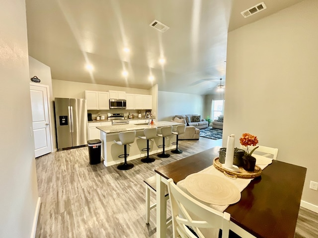 1311 Red Cliff Ave, Odessa, TX 79765 - dining room featuring light wood-style flooring, ceiling fan, and lofted ceiling
