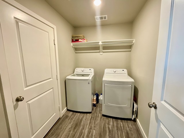 1311 Red Cliff Ave, Odessa, TX 79765 - laundry area featuring separate washer and dryer and wood finished floors