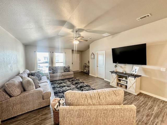 1311 Red Cliff Ave, Odessa, TX 79765 - living room featuring dark wood-style flooring, ceiling fan, lofted ceiling, and a textured ceiling