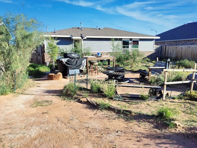 back of property featuring brick siding and fence