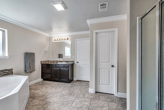 811 E 97th Ct, Odessa, TX 79765 - bathroom featuring healthy amount of natural light, vanity, a bath, a stall shower, and ornamental molding