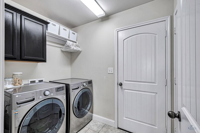811 E 97th Ct, Odessa, TX 79765 - laundry room with washer and dryer, cabinet space, light tile patterned flooring, and baseboards